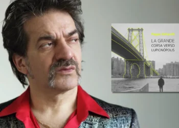 Copertina dell’album “La grande corsa verso Lupionòpolis” di Peppe Voltarelli: ritratto dell’artista e un ponte sullo sfondo.